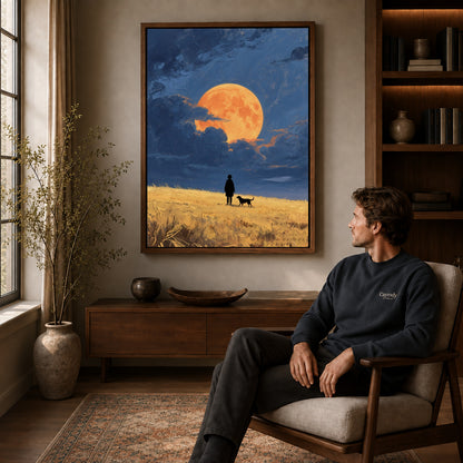 moonlit field companions canvas art in a walnut frame above a console beside a seated man.