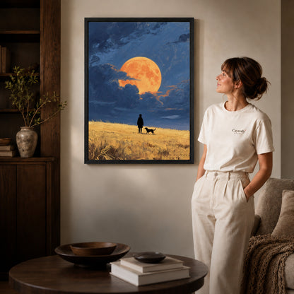 moonlit field companions canvas art in a black frame beside a woman and round wooden table.