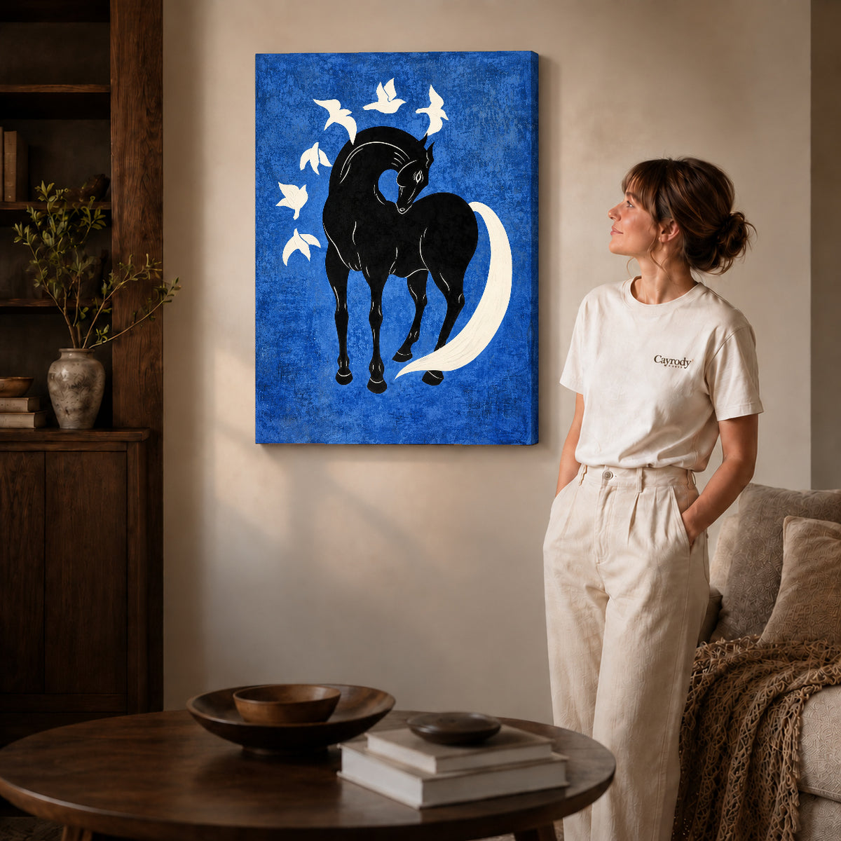 horse bird harmony canvas art on gallery-wrapped canvas with natural edge shading beside a standing woman.