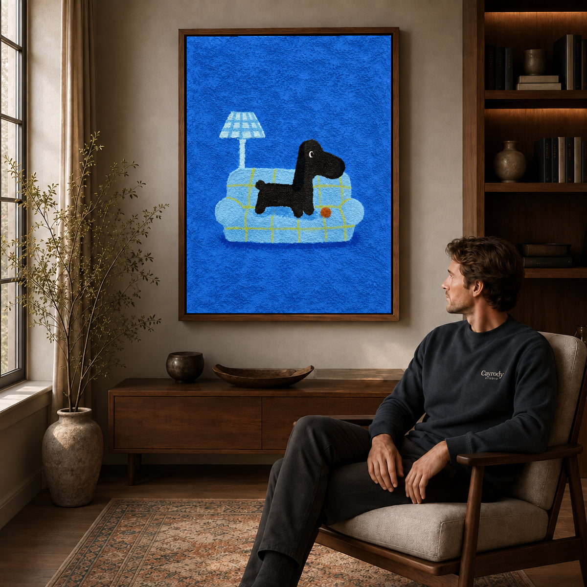 cozy plaid companion canvas art in a walnut frame above a console beside a seated man.
