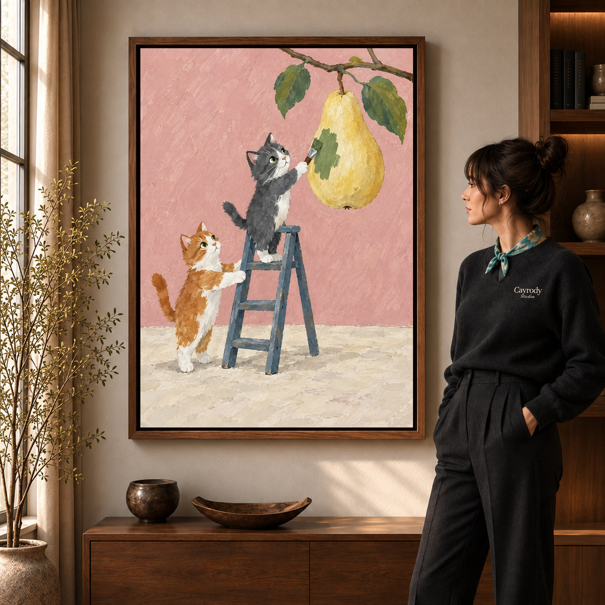 little pear painters canvas art in a walnut frame beside a standing woman and wooden console.