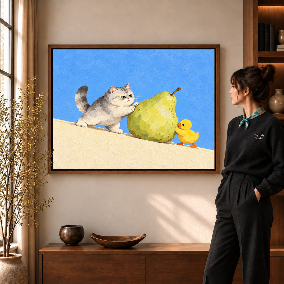 pear push partners canvas art in a walnut frame beside a standing woman and wooden console.