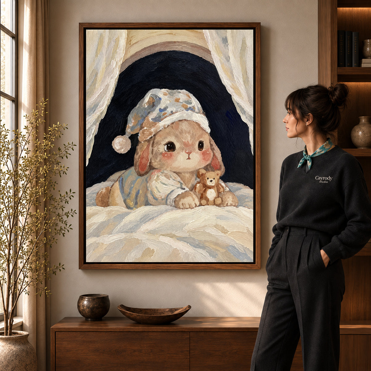 sleepy rabbit retreat canvas art in a walnut frame beside a standing woman and wooden console.