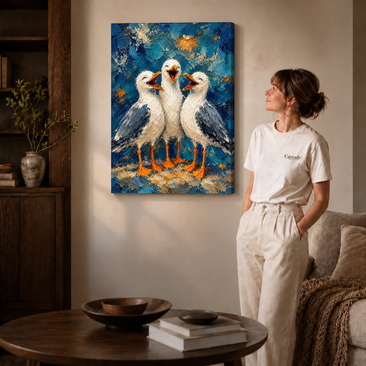 laughing seagull trio canvas art on gallery-wrapped canvas with natural edge shading beside a standing woman.