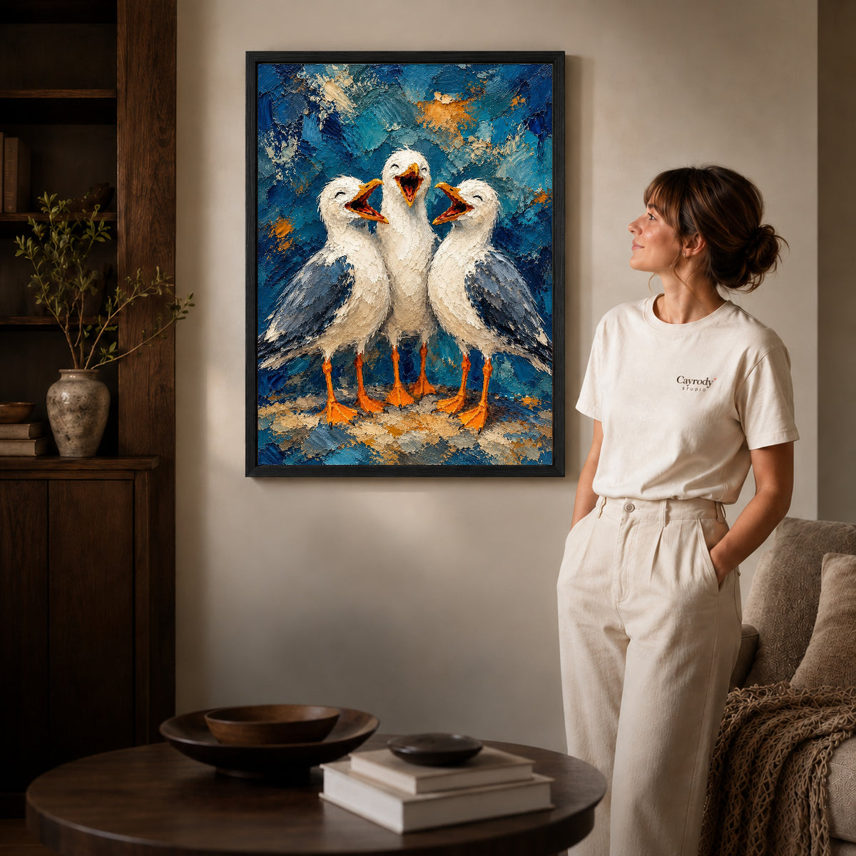 laughing seagull trio canvas art shown in the black frame option against a softly lit wall.