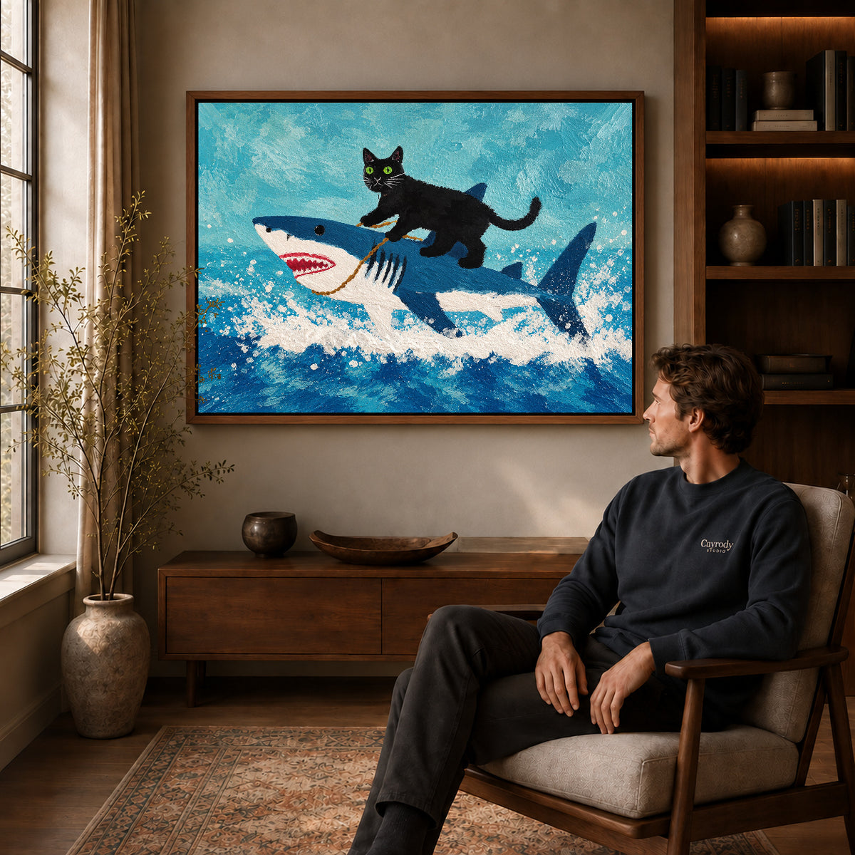 cat shark adventure canvas art in a walnut frame above a console beside a seated man.