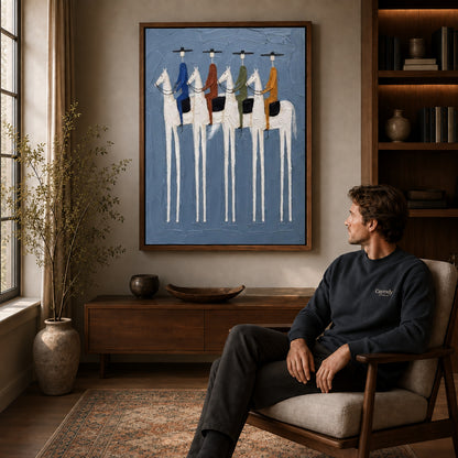 four riders together canvas art in a walnut frame above a console beside a seated man.