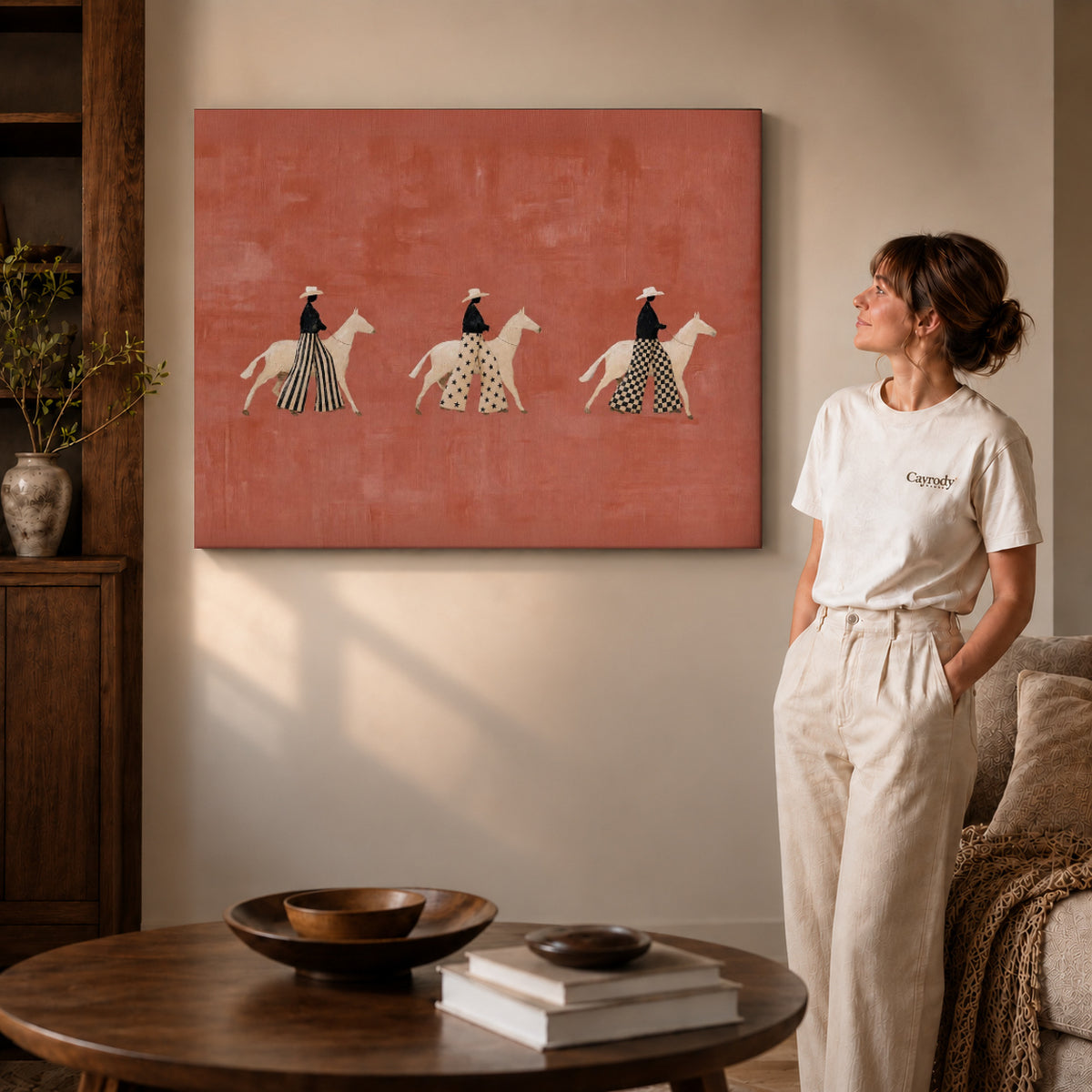 patterned rider parade canvas art on gallery-wrapped canvas with visible edge depth beside a standing woman.