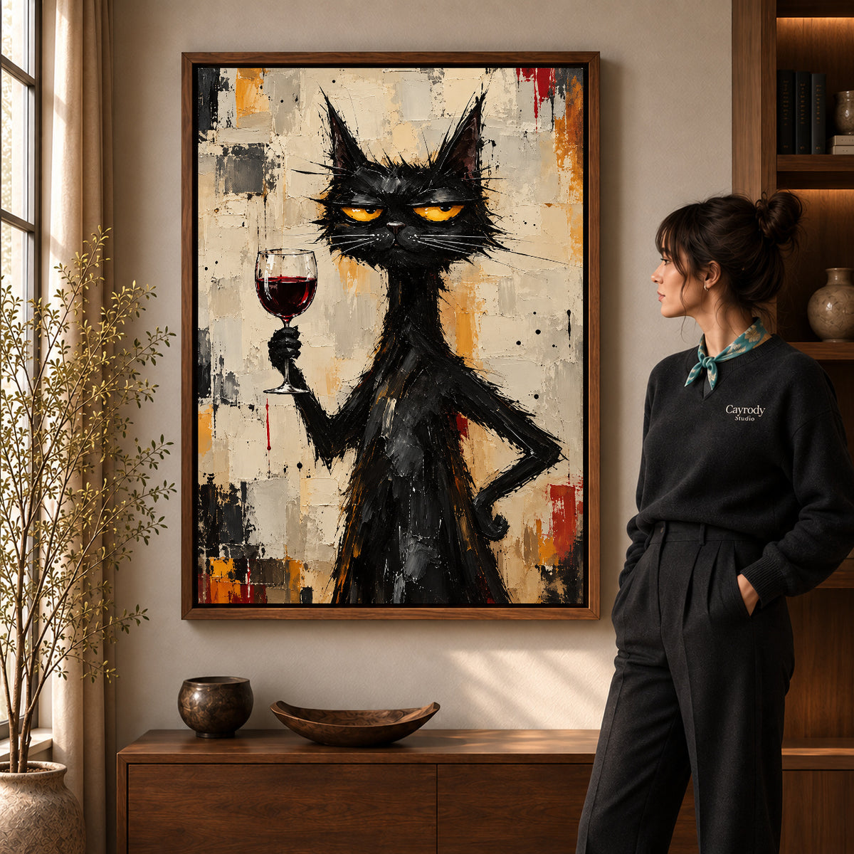 unimpressed wine cat canvas art in a walnut frame beside a standing woman and wooden console.
