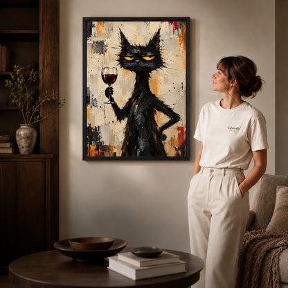 unimpressed wine cat canvas art in a black frame beside a woman and round wooden table.
