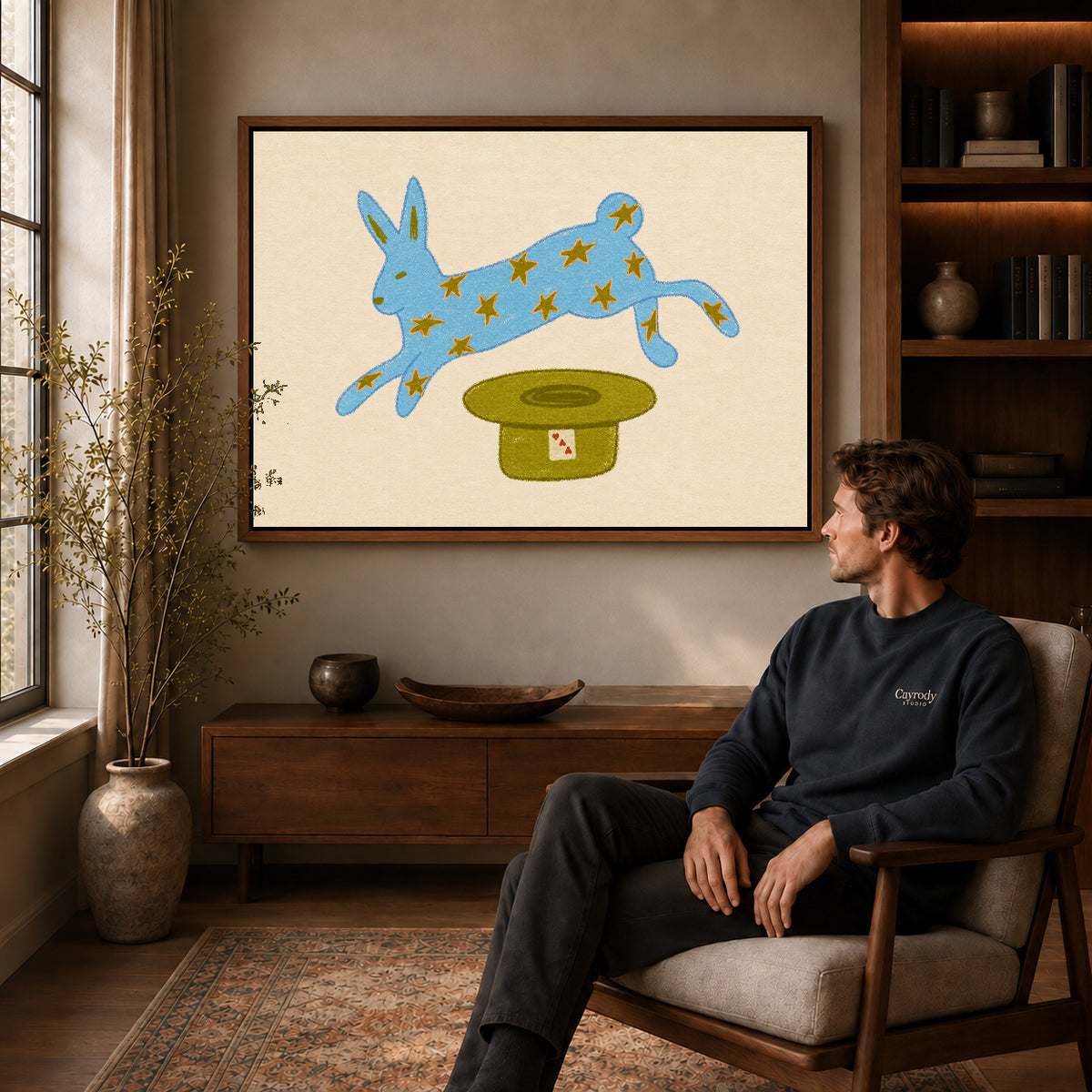 star rabbit magic canvas art in a walnut frame above a console beside a seated man.