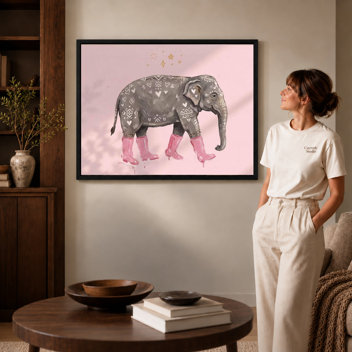 pink boot elephant canvas art shown in the black frame option against a softly lit wall.