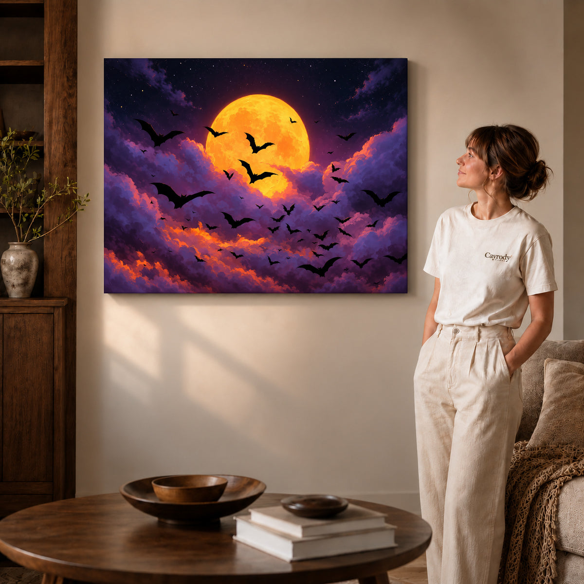 golden moon bats canvas art on gallery-wrapped canvas with visible edge depth beside a standing woman.