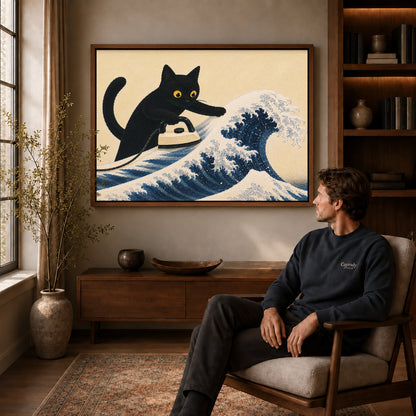 cat wave ironing canvas art in a walnut frame above a console beside a seated man.