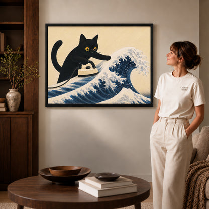 cat wave ironing canvas art in a black frame beside a woman and round wooden table.