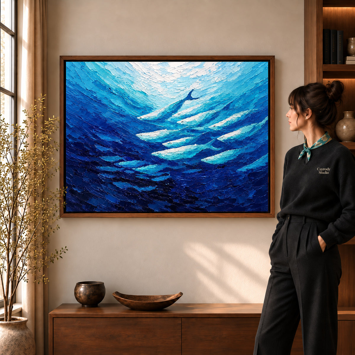 cobalt fish current canvas art shown in the walnut frame option within a warm living room.