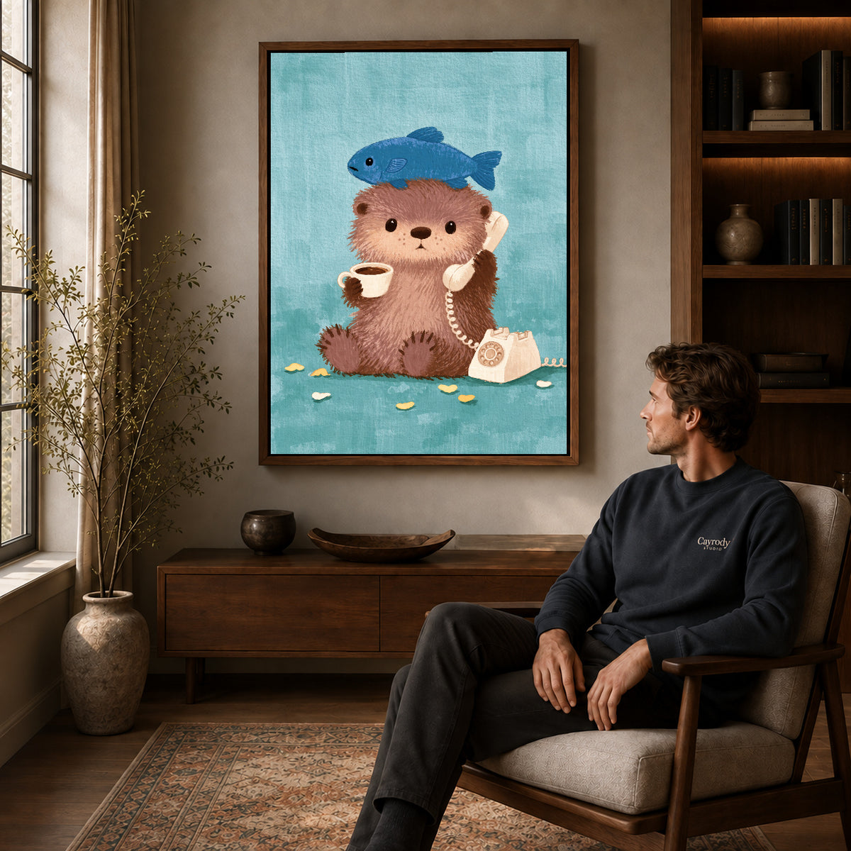 otter coffee call canvas art in a walnut frame above a console beside a seated man.