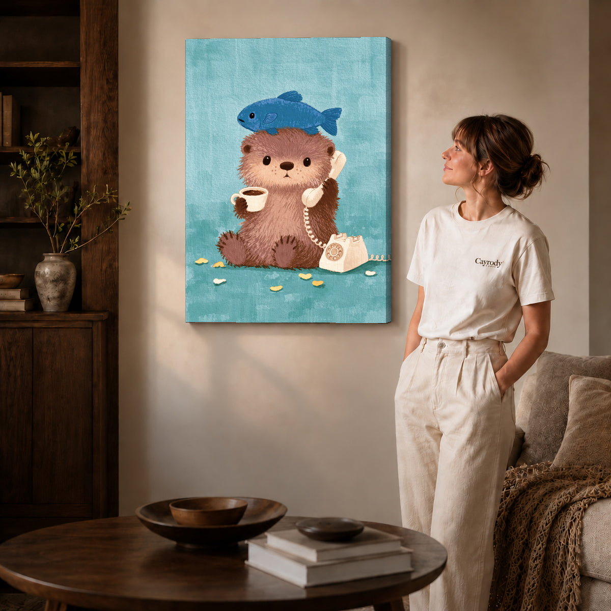 otter coffee call canvas art on gallery-wrapped canvas with natural edge shading beside a standing woman.