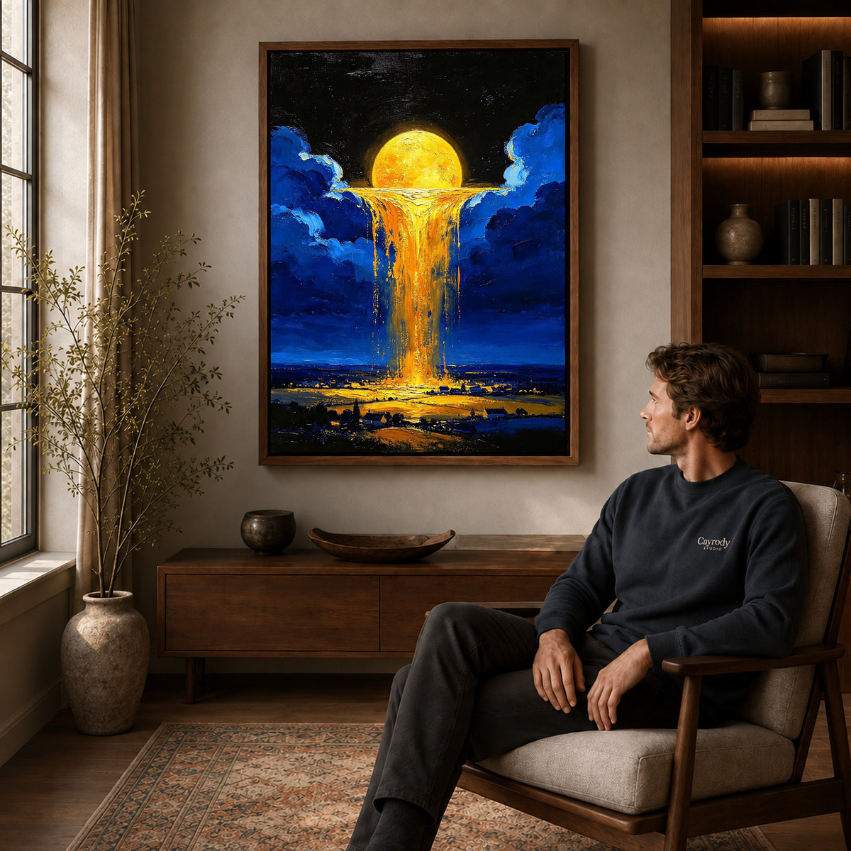 golden sky cascade canvas art in a walnut frame above a console beside a seated man.
