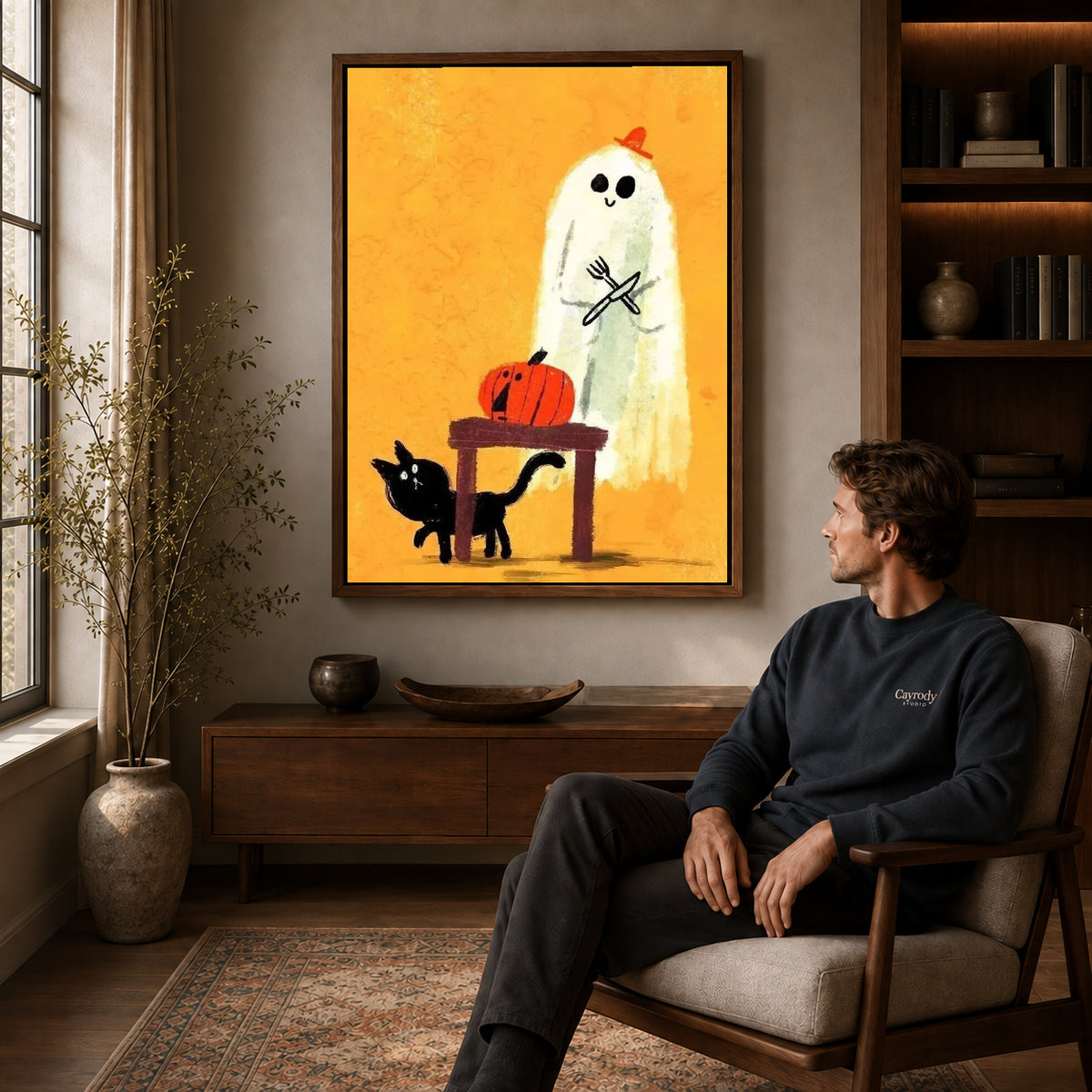 ghost dinner surprise canvas art in a walnut frame above a console beside a seated man.