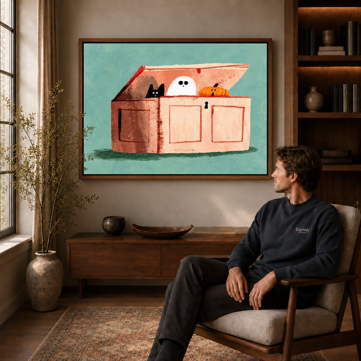 little chest surprises canvas art in a walnut frame above a console beside a seated man.
