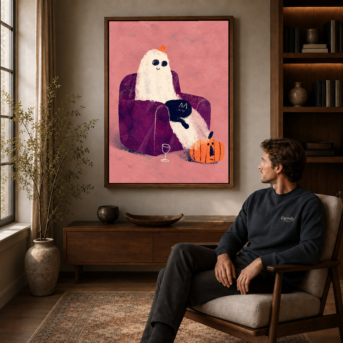 ghost armchair evening canvas art in a walnut frame above a console beside a seated man.