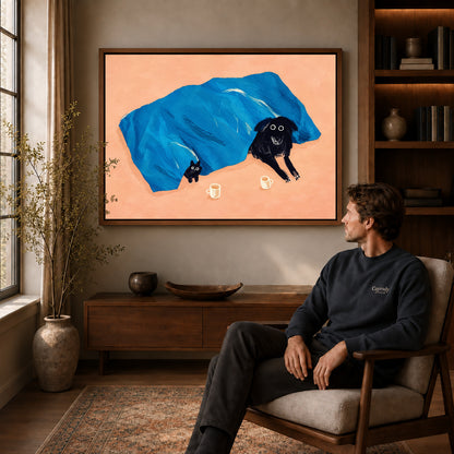 cozy blanket companions canvas art in a walnut frame above a console beside a seated man.