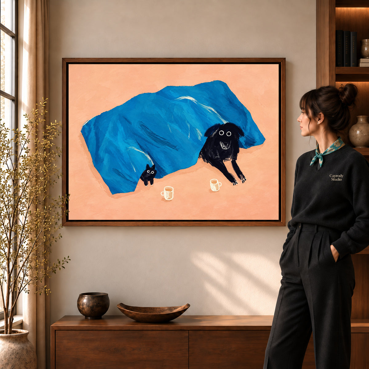 cozy blanket companions canvas art shown in the walnut frame option within a warm living room.