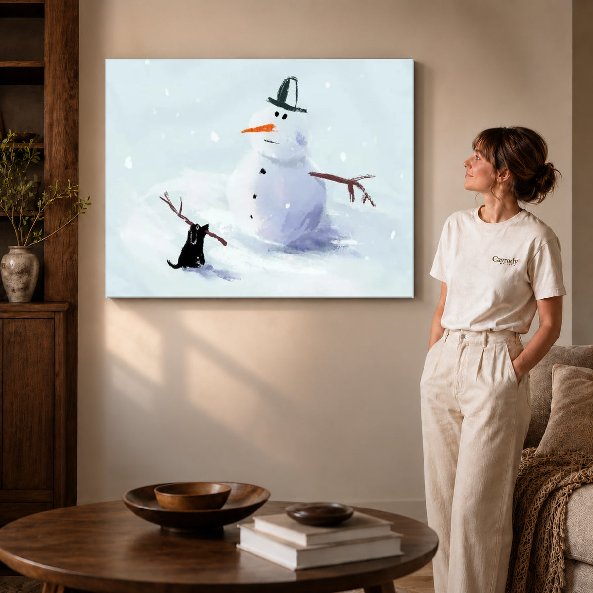 snowman stick mischief canvas art on gallery-wrapped canvas with visible edge depth beside a standing woman.