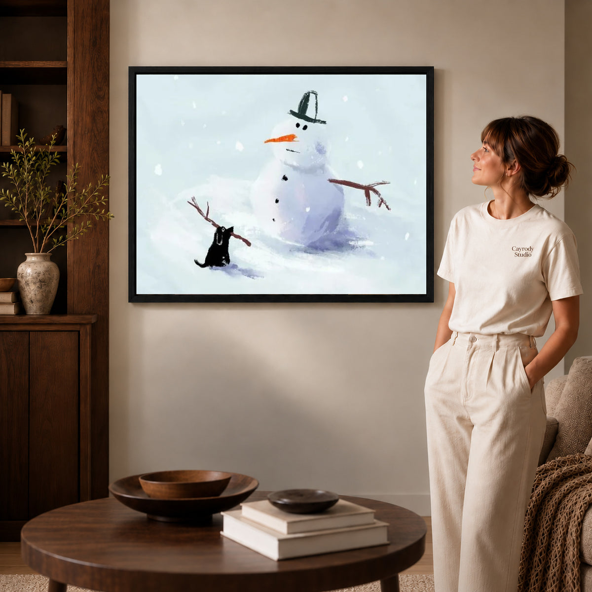 snowman stick mischief canvas art shown in the black frame option against a softly lit wall.