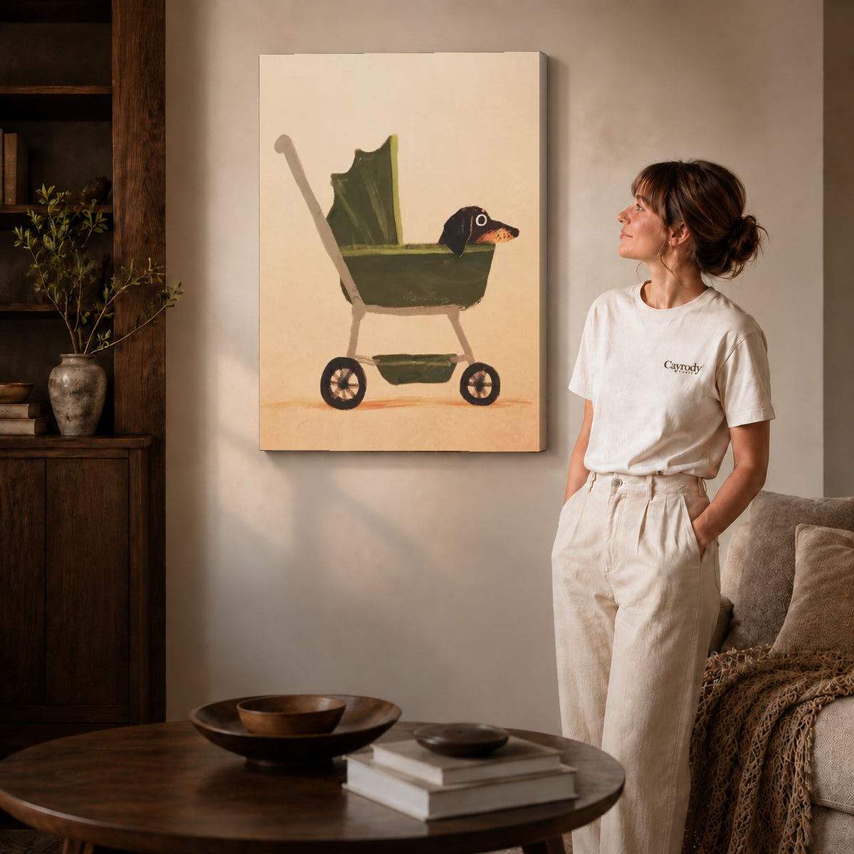 dachshund pram ride canvas art on gallery-wrapped canvas with natural edge shading beside a standing woman.