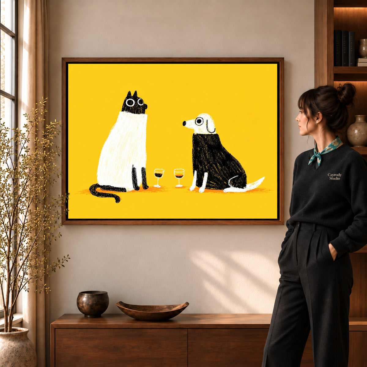 blanket wine companions canvas art in a walnut frame beside a standing woman and wooden console.