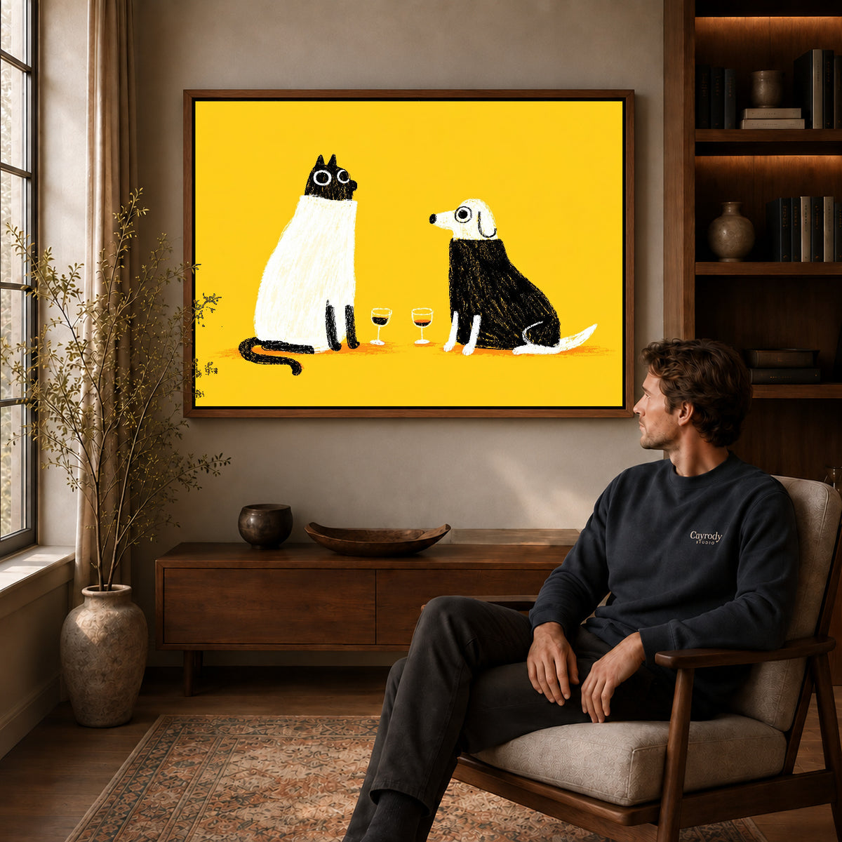 blanket wine companions canvas art in a walnut frame above a console beside a seated man.