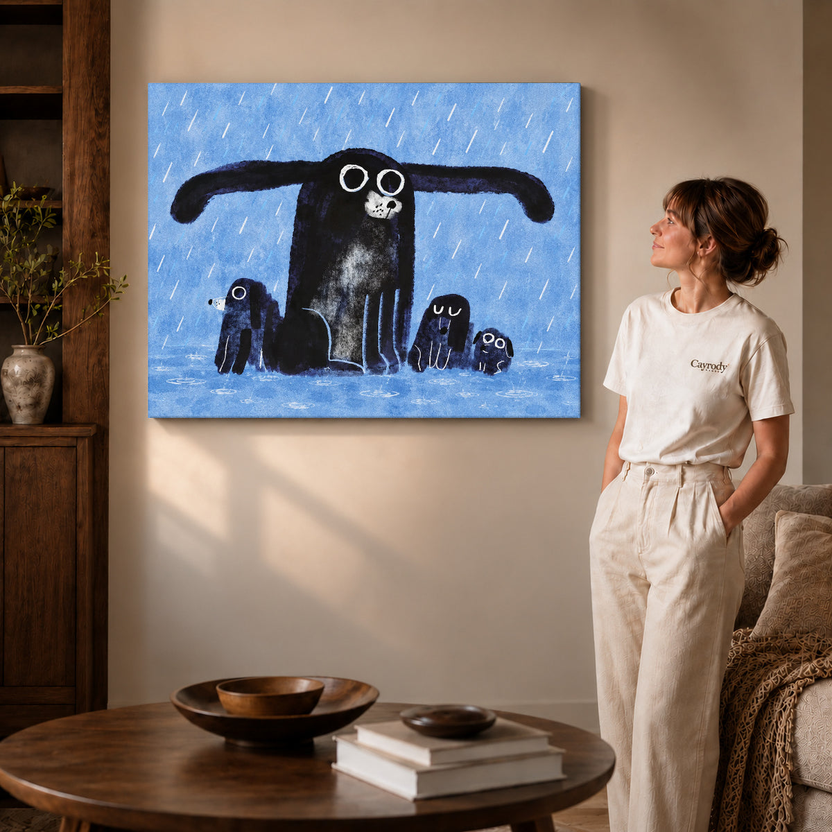 sheltering dog family canvas art on gallery-wrapped canvas with visible edge depth beside a standing woman.