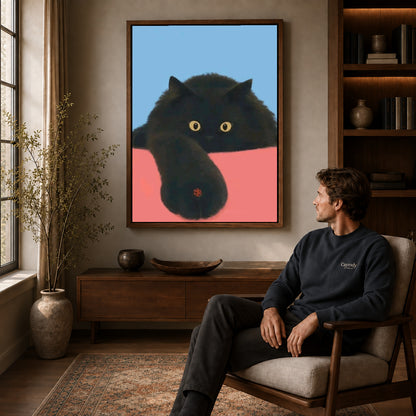 ladybug paw pause canvas art in a walnut frame above a console beside a seated man.