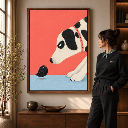 dog meets tiny bird canvas art in a walnut frame beside a standing woman and wooden console.