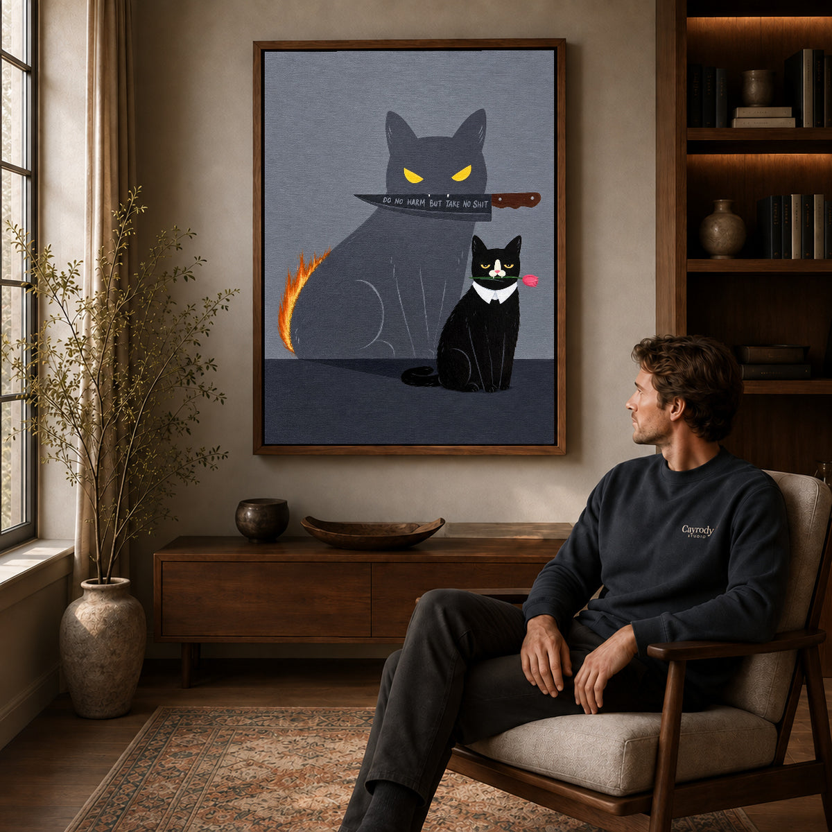 rose cat bold shadow canvas art in a walnut frame above a console beside a seated man.