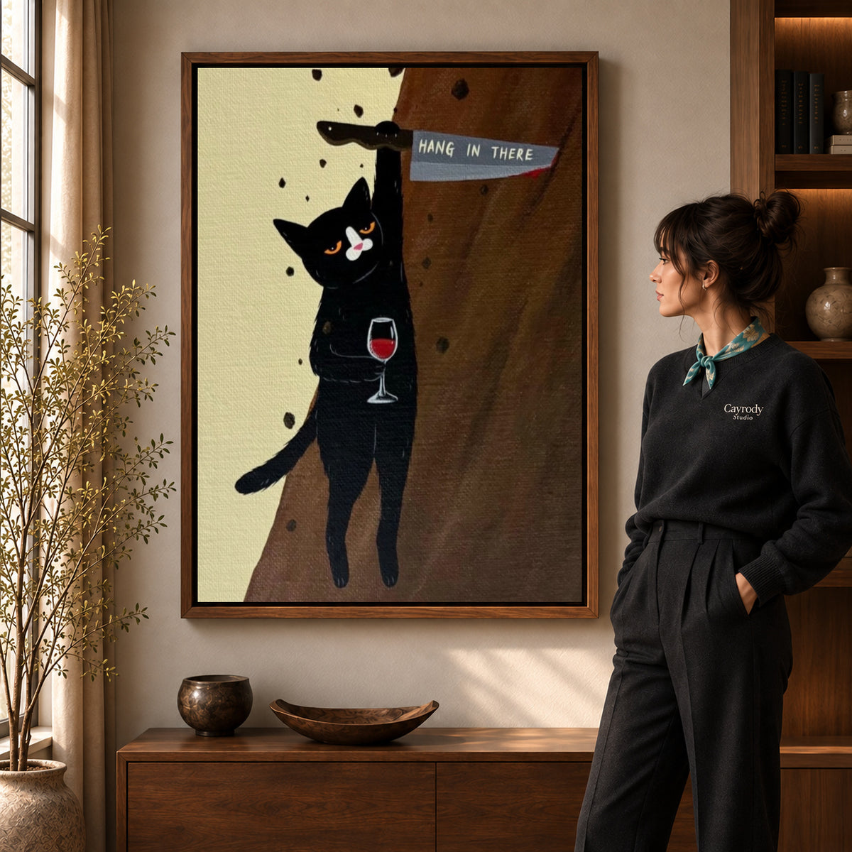 hang in there cat canvas art shown in the walnut frame option within a warm living room.