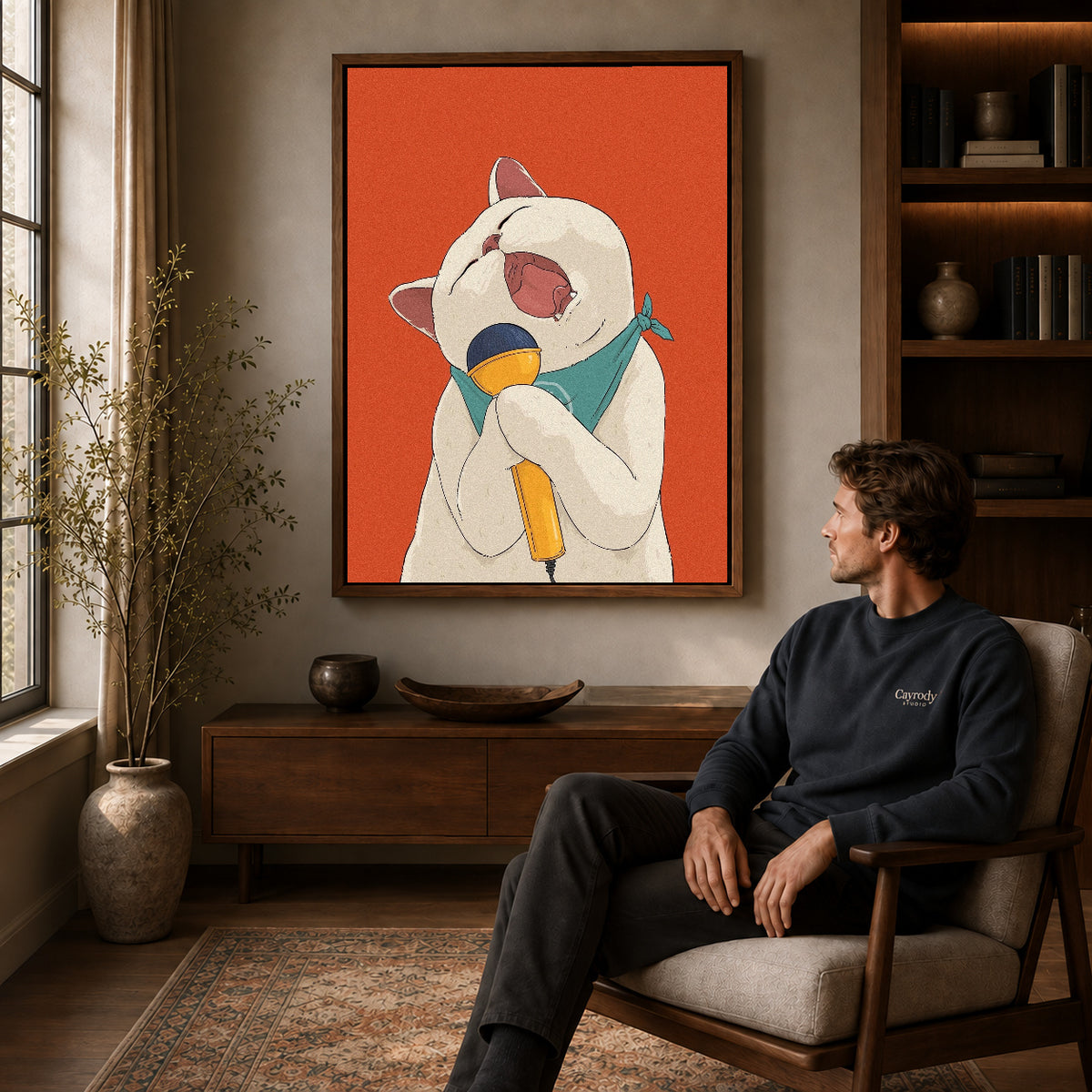 singing cat serenade canvas art in a walnut frame above a console beside a seated man.