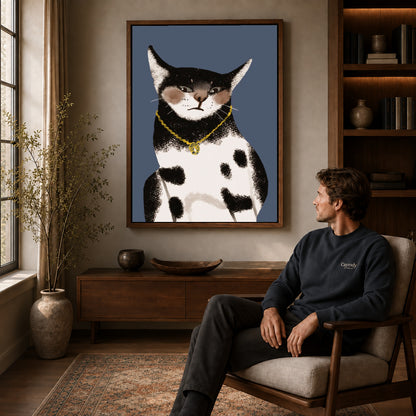 golden pendant cat canvas art in a walnut frame above a console beside a seated man.