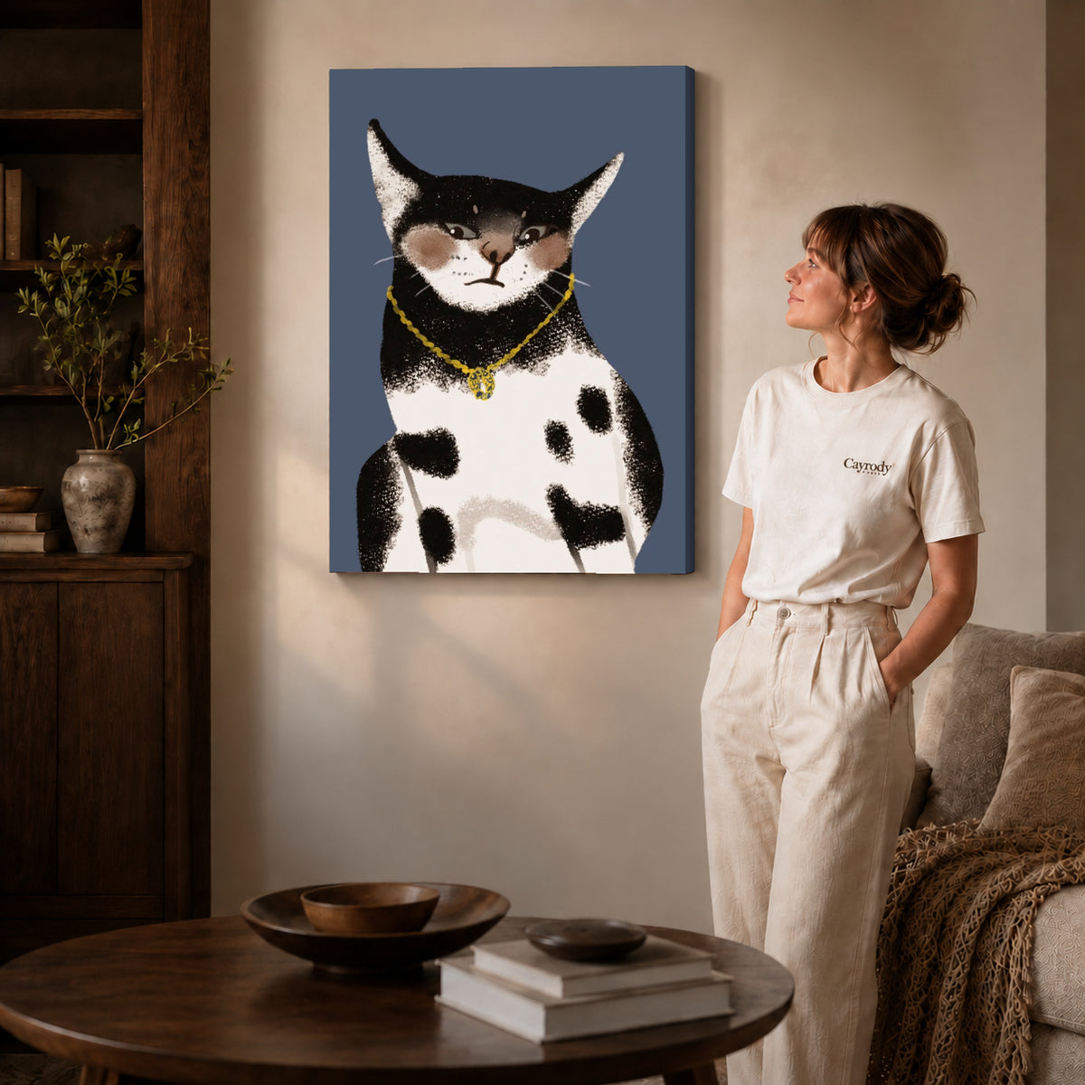 golden pendant cat canvas art on gallery-wrapped canvas with natural edge shading beside a standing woman.