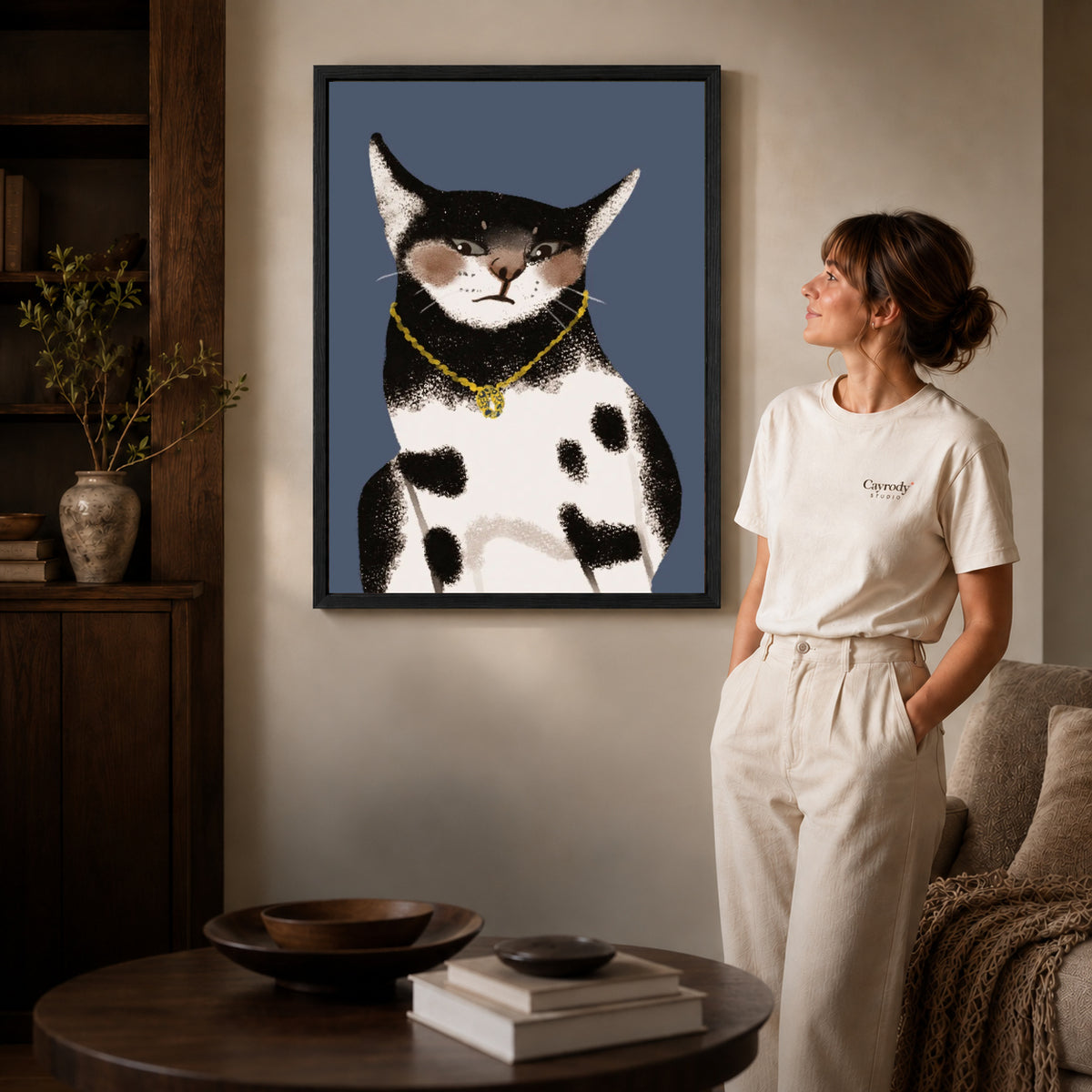 golden pendant cat canvas art shown in the black frame option against a softly lit wall.