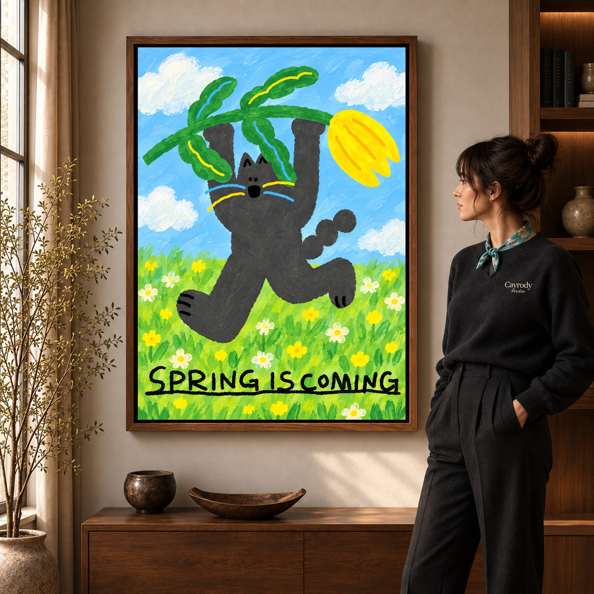 spring tulip cat canvas art in a walnut frame beside a standing woman and wooden console.