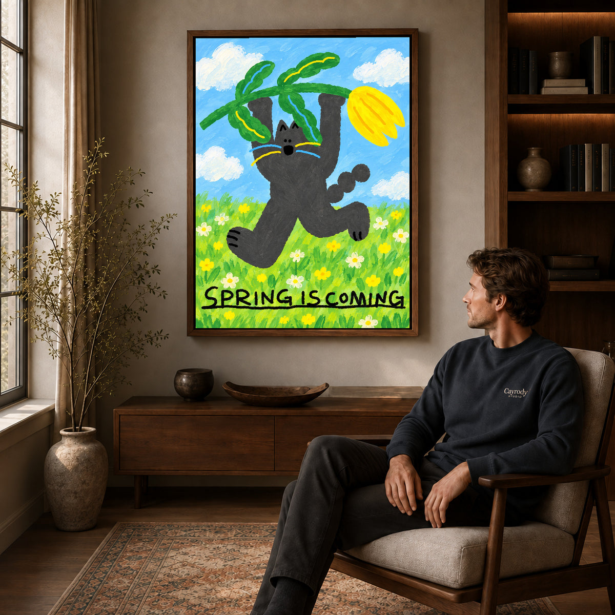spring tulip cat canvas art in a walnut frame above a console beside a seated man.