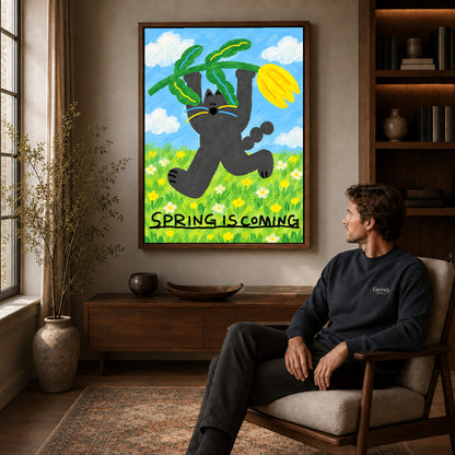 spring tulip cat canvas art in a walnut frame above a console beside a seated man.