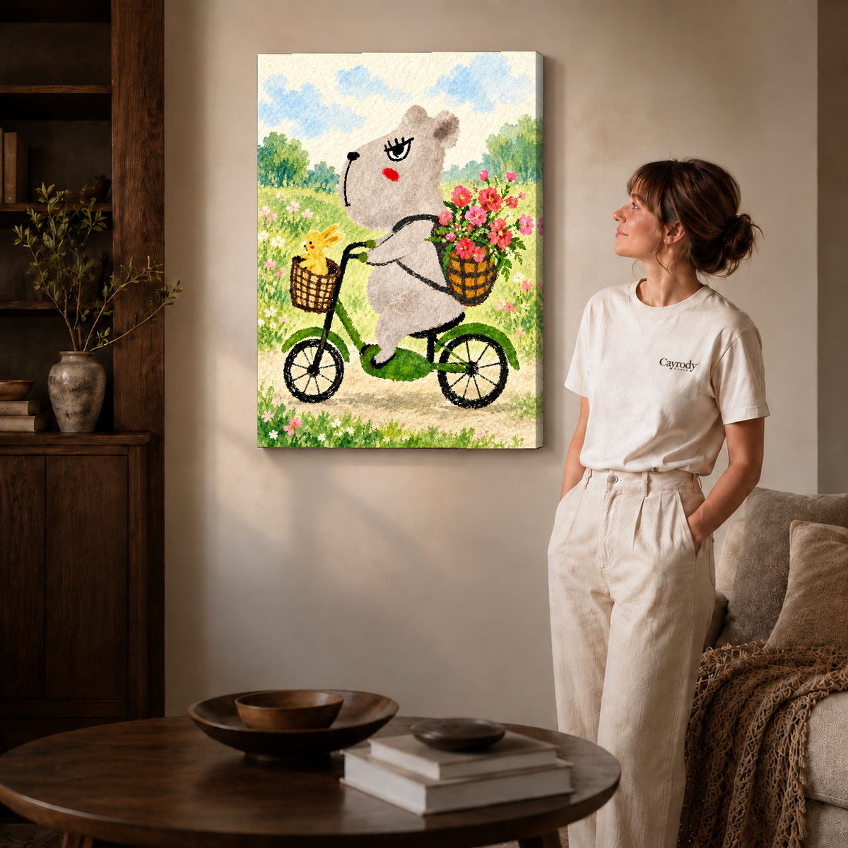 capybara bicycle ride canvas art on gallery-wrapped canvas with natural edge shading beside a standing woman.