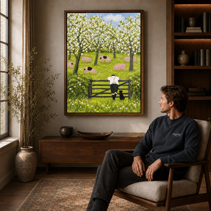 blossom orchard companions canvas art in a walnut frame above a console beside a seated man.