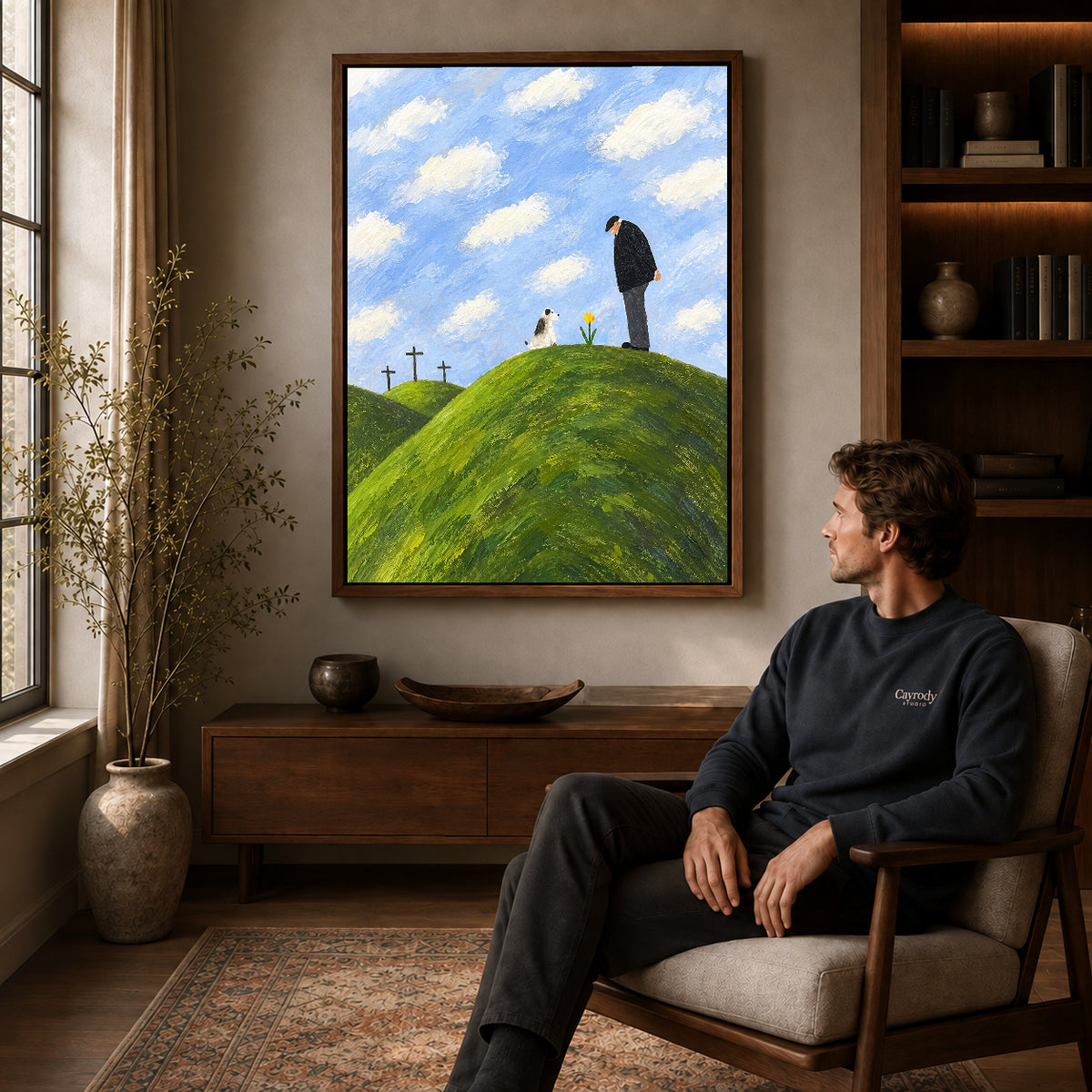 hilltop remembrance canvas art in a walnut frame above a console beside a seated man.