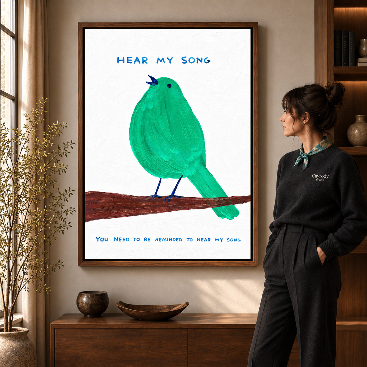 hear my song canvas art in a walnut frame beside a standing woman and wooden console.