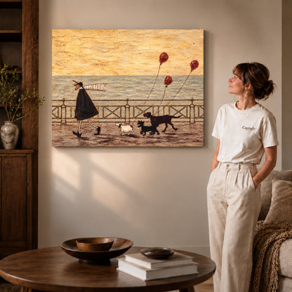seaside dog walk canvas art on gallery-wrapped canvas with visible edge depth beside a standing woman.
